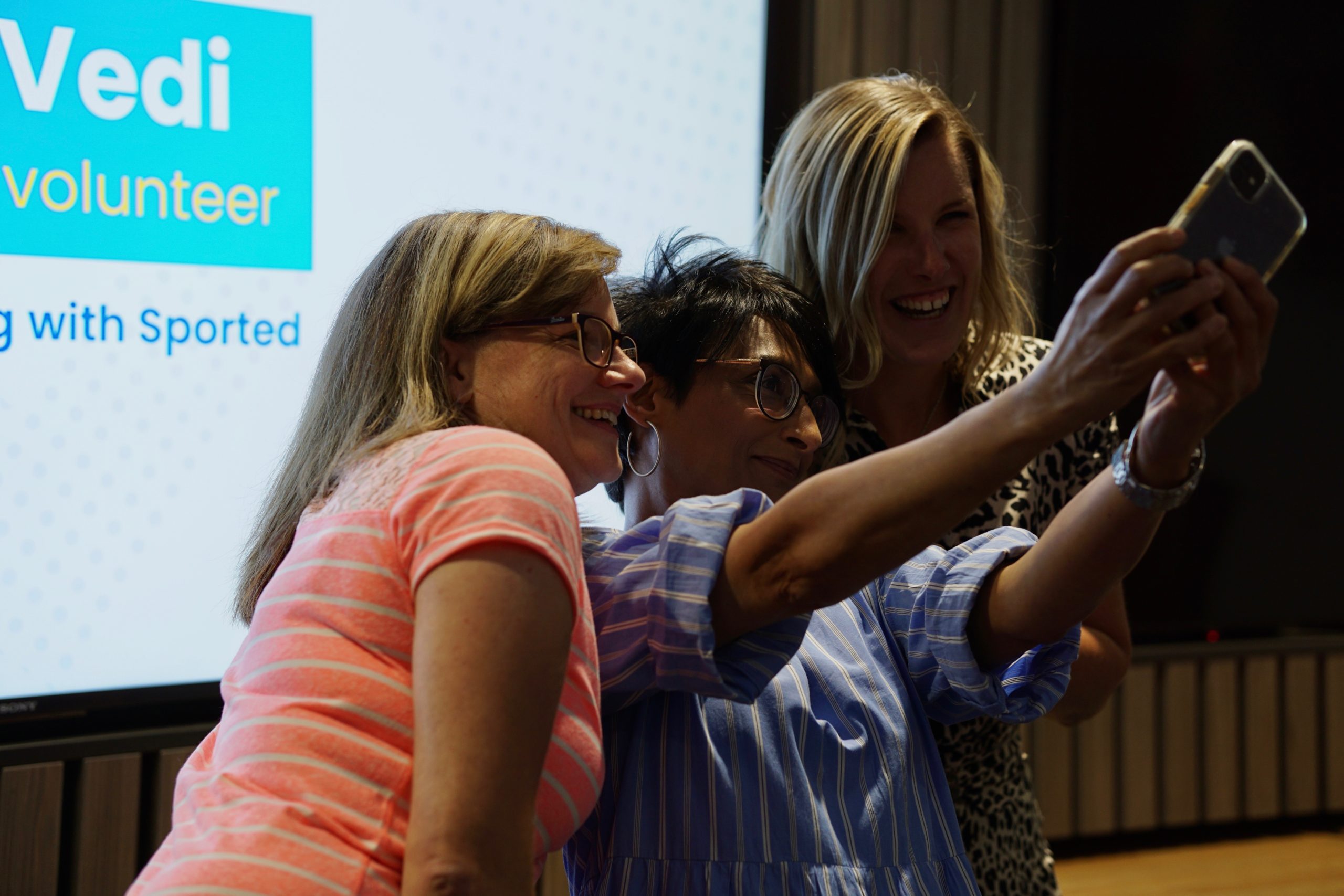 Three women posing for a selfit