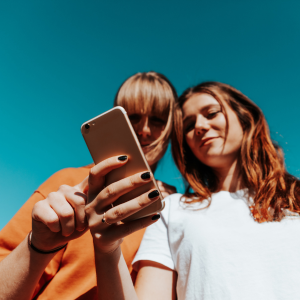 two women looking at a mobile